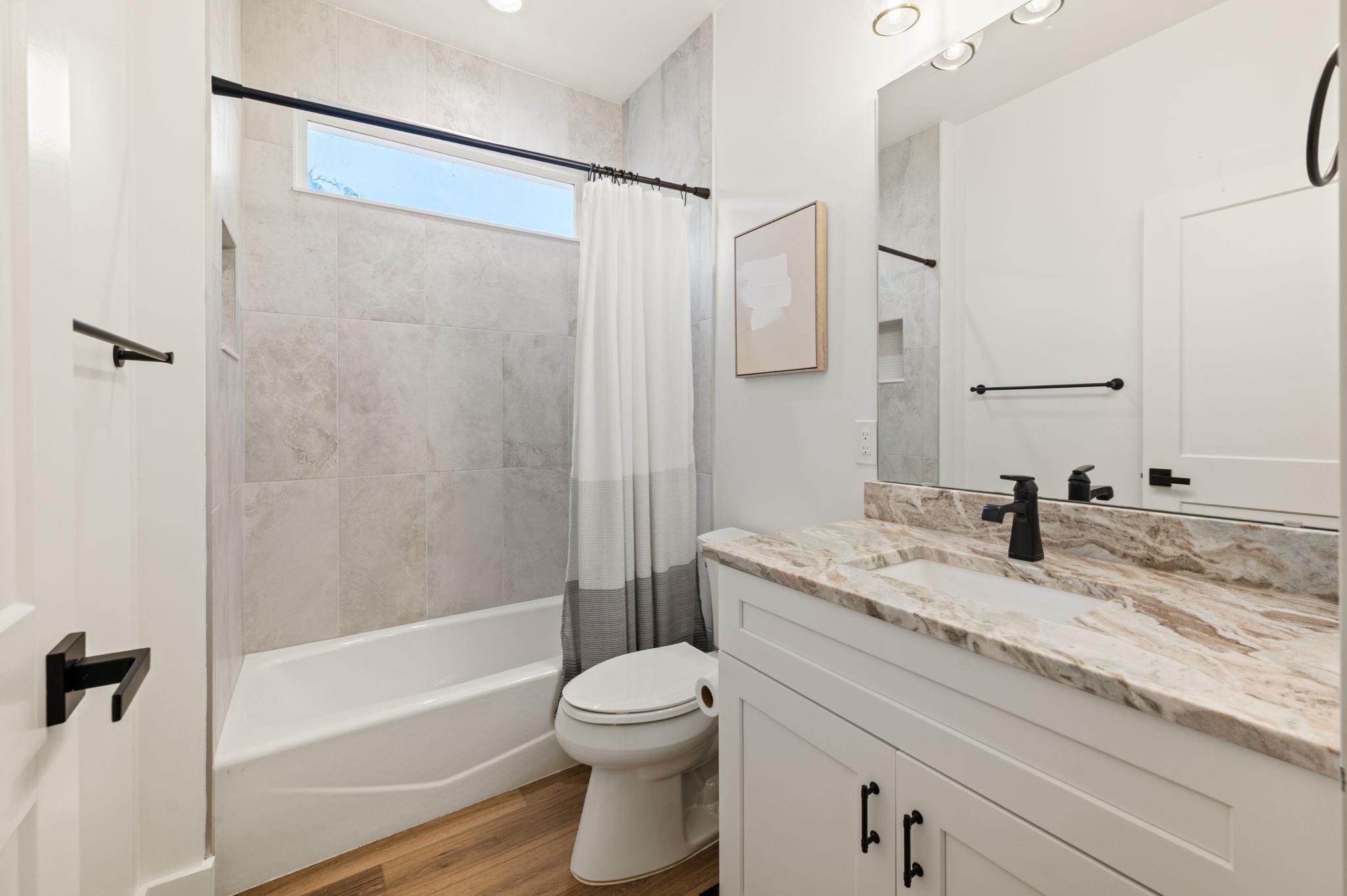 135 Blanco Street St. Augustine, FL 32084 - Photo 26 of 35 a bathroom with a granite countertop sink toilet and shower