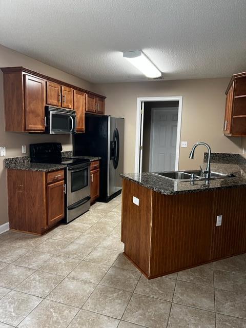 25 3rd Street Shalimar, FL 32579 - Photo 7 of 14 a kitchen with stainless steel appliances granite countertop a refrigerator and a sink