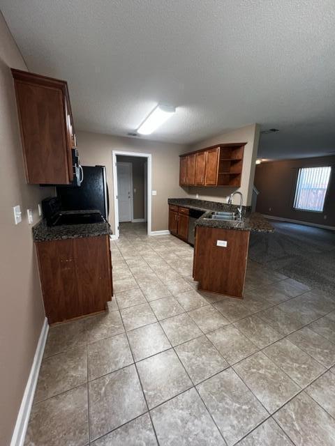 25 3rd Street Shalimar, FL 32579 - Photo 8 of 14 a kitchen with granite countertop a refrigerator and a stove top oven