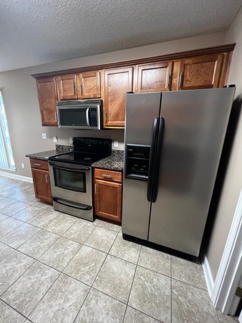 25 3rd Street Shalimar, FL 32579 - Photo 9 of 14 a kitchen with granite countertop a refrigerator and a stove top oven