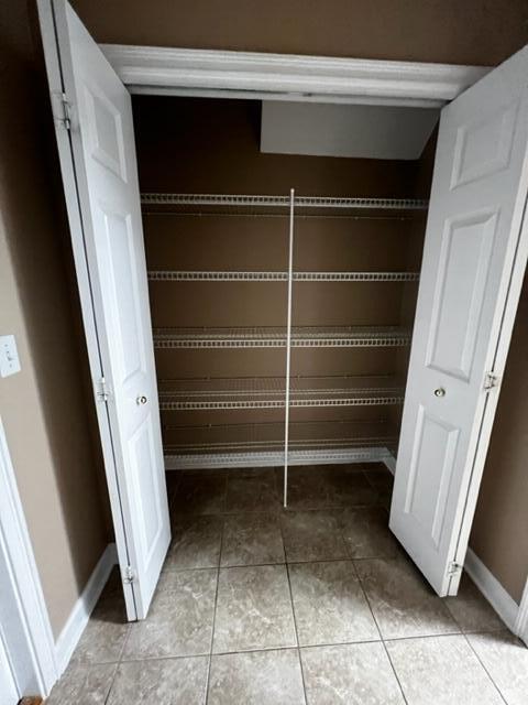 25 3rd Street Shalimar, FL 32579 - Photo 10 of 14 a view of walk in closet with empty racks