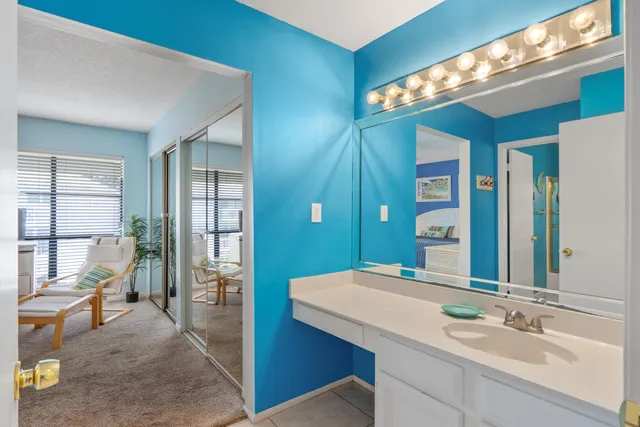 a en suite bathroom with a sink a large mirror and a shower