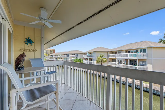 a dining room with furniture a chandelier and wooden floor