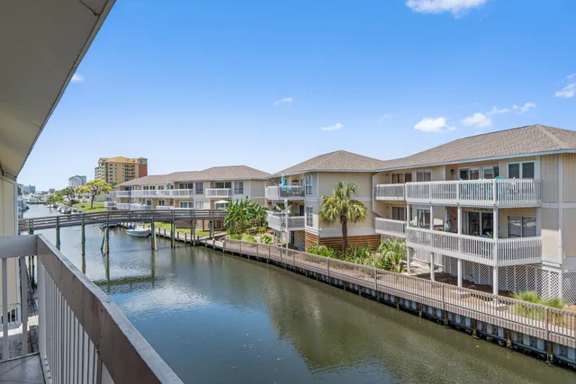 a balcony with furniture and view of lake