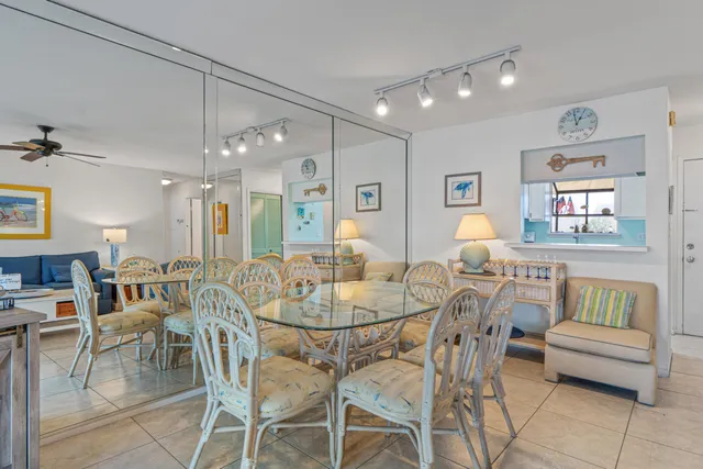 a dining room with furniture and a chandelier