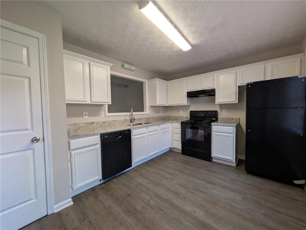 4341 Logan Way Acworth, GA 30101 - Photo 3 of 17 a kitchen with a refrigerator a sink a stove top oven and cabinets