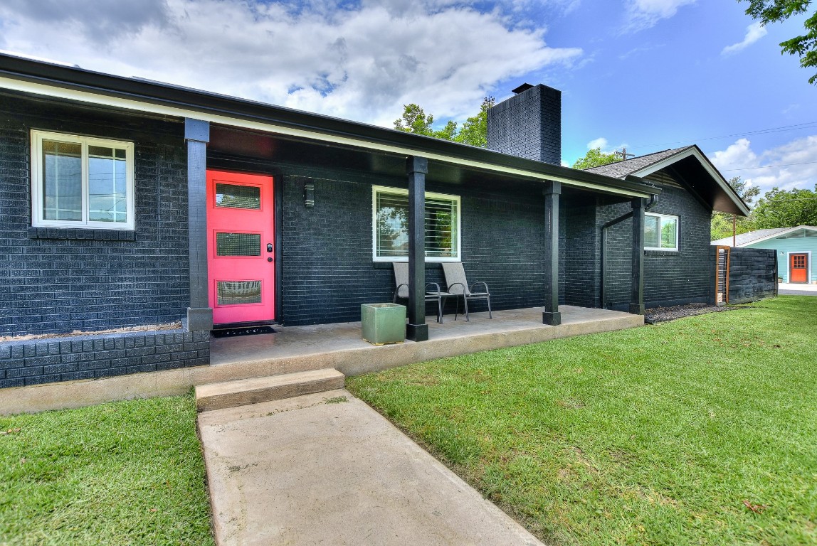a front view of a house with a yard and porch