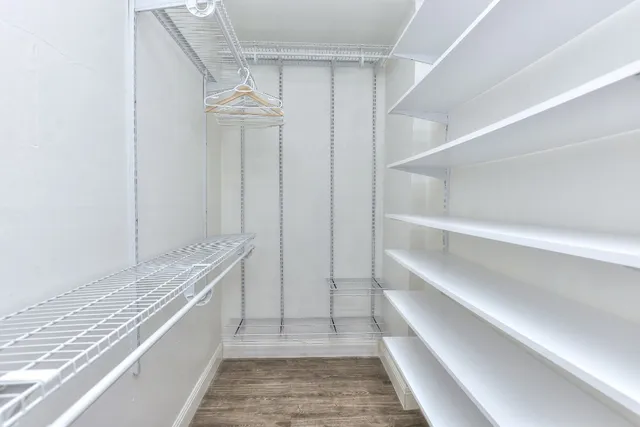 a bathroom with a toilet a sink a mirror and a shower