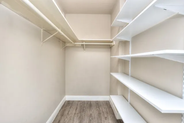 a bathroom with a sink a toilet a mirror and shower