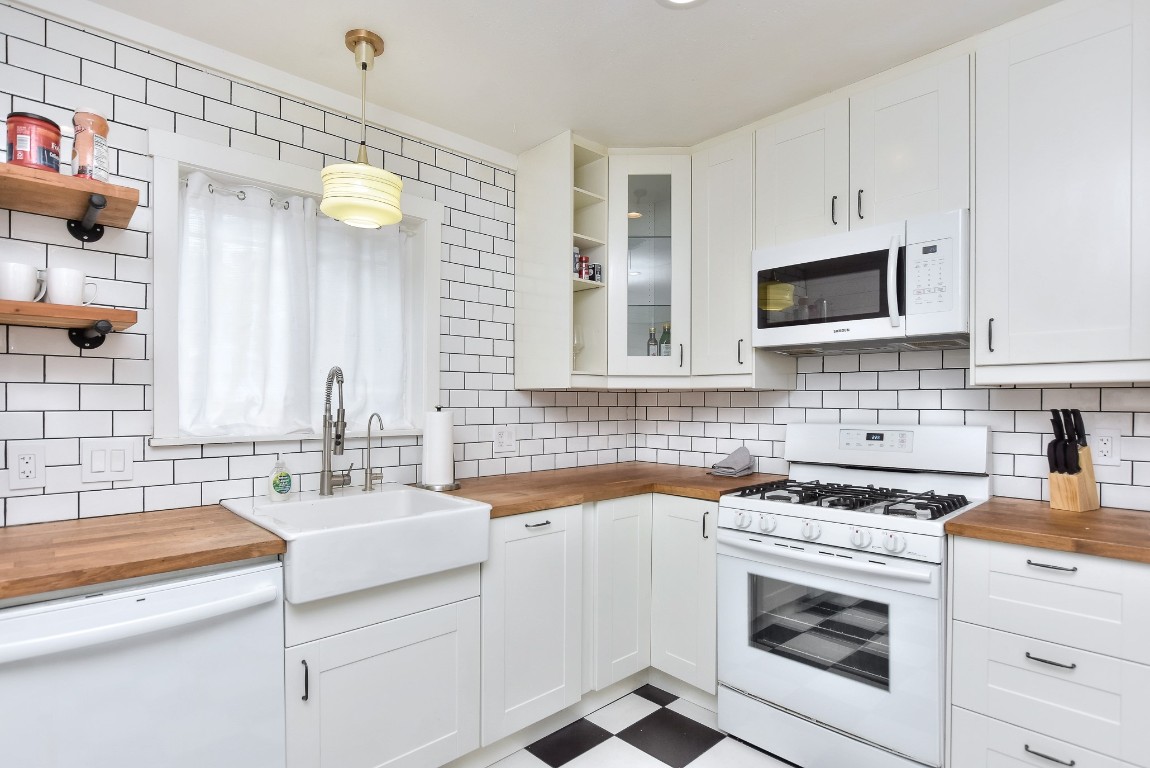 1407 East 19th Street Georgetown, TX 78626 - Photo 20 of 36 a kitchen with cabinets appliances a sink and a counter top space