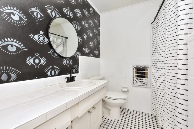 a view of a backyard with a patio and wooden fence