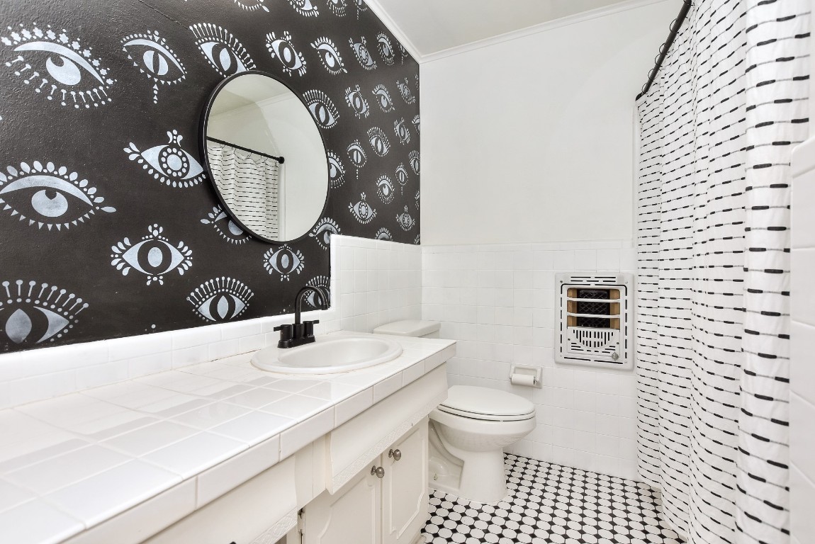1407 East 19th Street Georgetown, TX 78626 - Photo 25 of 36 a bathroom with a toilet a sink and a mirror