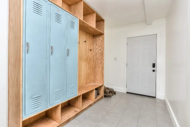 a view of a backyard with table and chairs and a barbeque