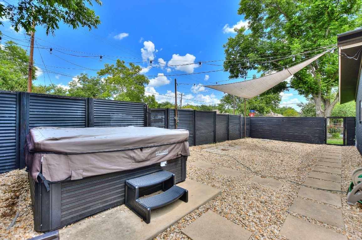 1407 East 19th Street Georgetown, TX 78626 - Photo 34 of 36 a view of a backyard with a patio and wooden fence
