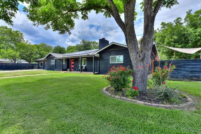 a front view of a house with garden