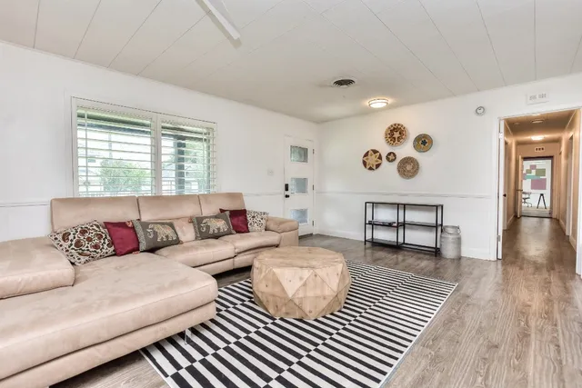a living room with furniture and wooden floor
