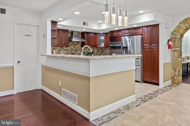 a view of kitchen with refrigerator stove and oven