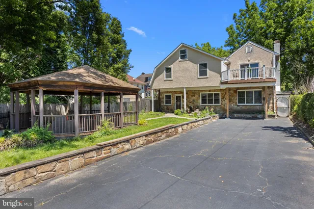 a front view of a house with a yard table and chairs