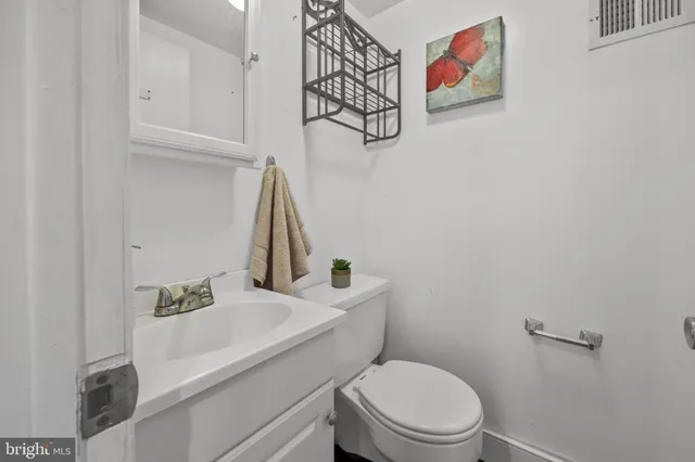 a white toilet sitting next to a bathroom sink