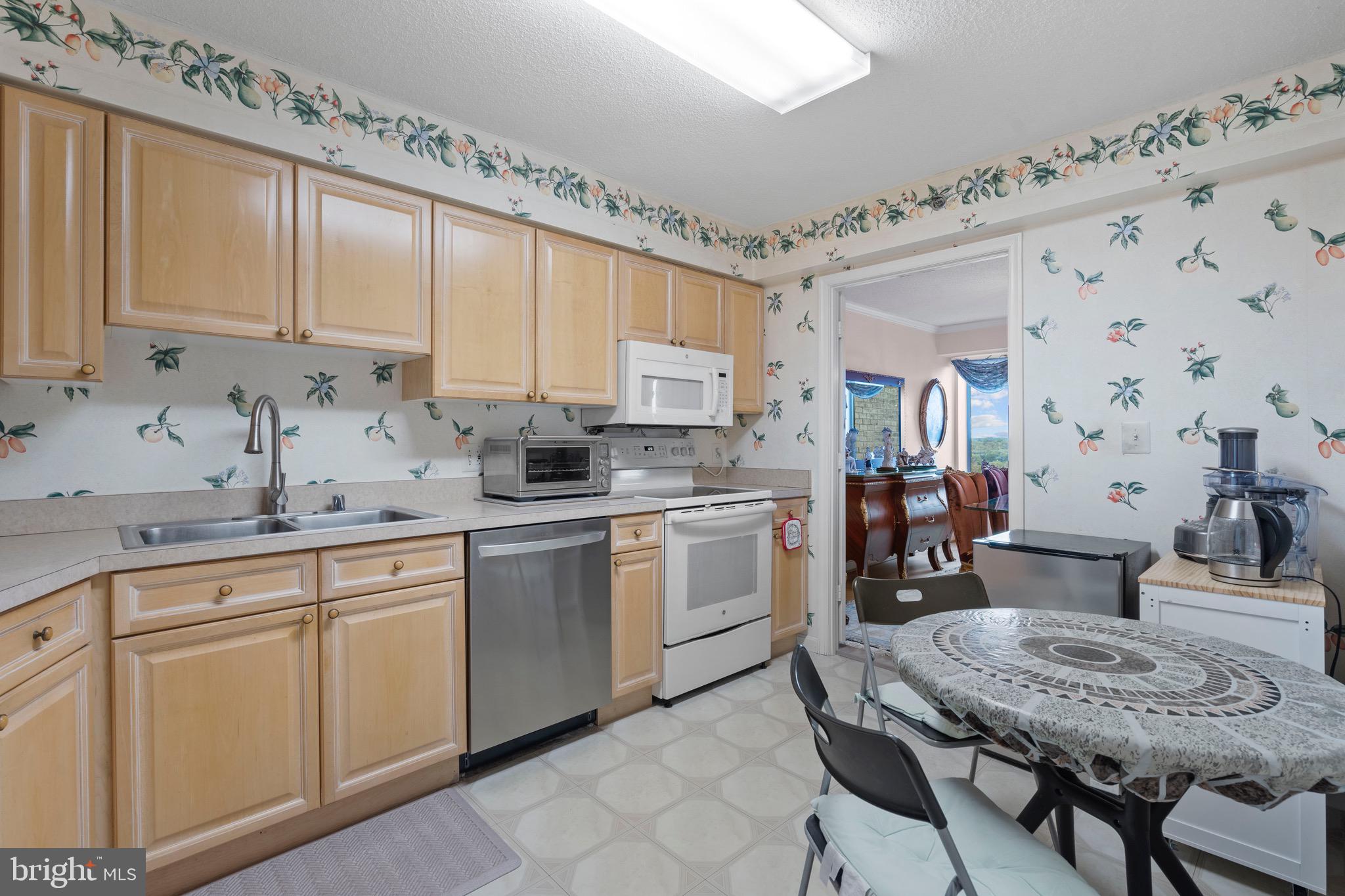 19385 Cypress Ridge Terrace, Unit 914 Leesburg, VA 20176 - Photo 14 of 39 a kitchen with white cabinets and sink