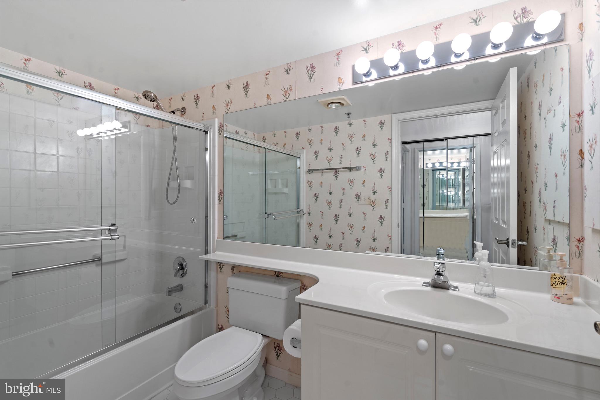 19385 Cypress Ridge Terrace, Unit 914 Leesburg, VA 20176 - Photo 16 of 39 a bathroom with a sink a toilet and shower