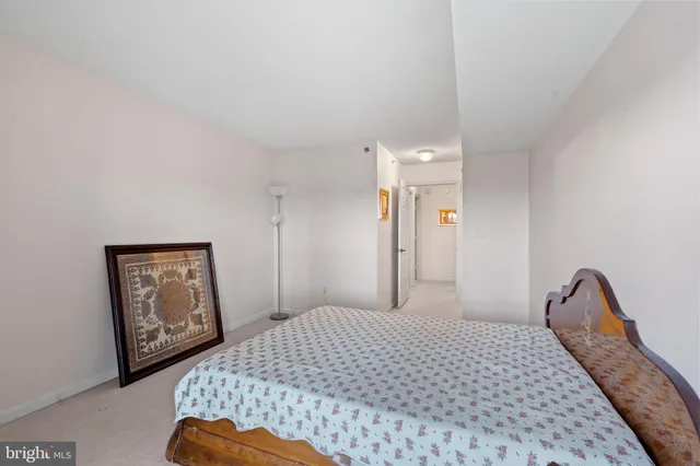 a bedroom with a large bed and a large window