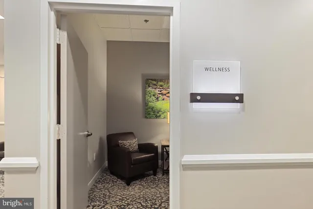 a living room with furniture and a bookshelf