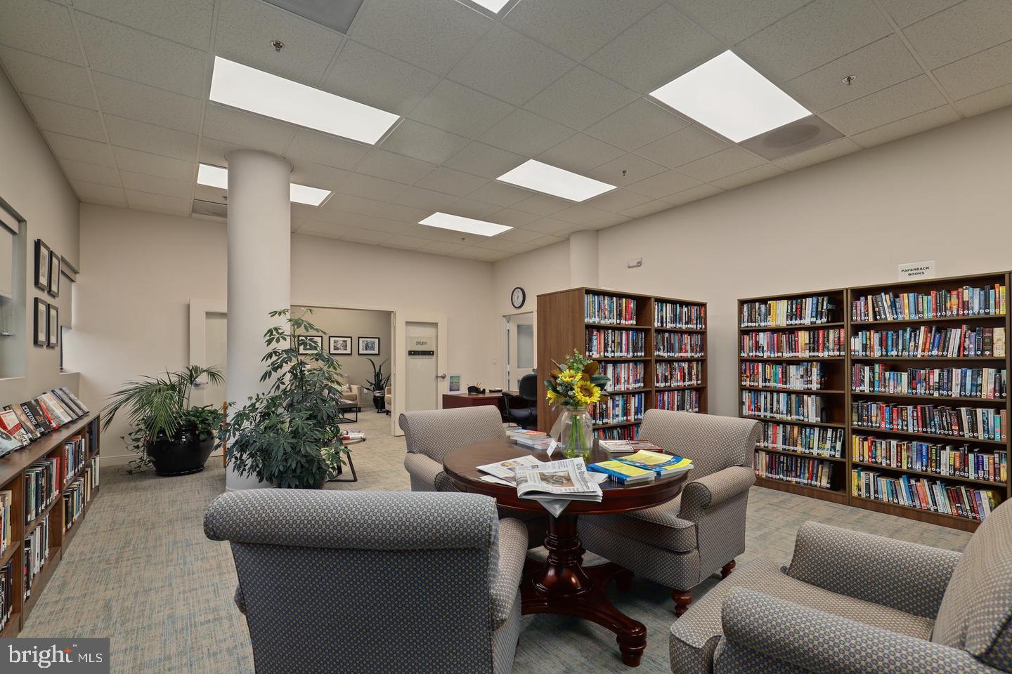 19385 Cypress Ridge Terrace, Unit 914 Leesburg, VA 20176 - Photo 37 of 39 a living room with furniture and a bookshelf