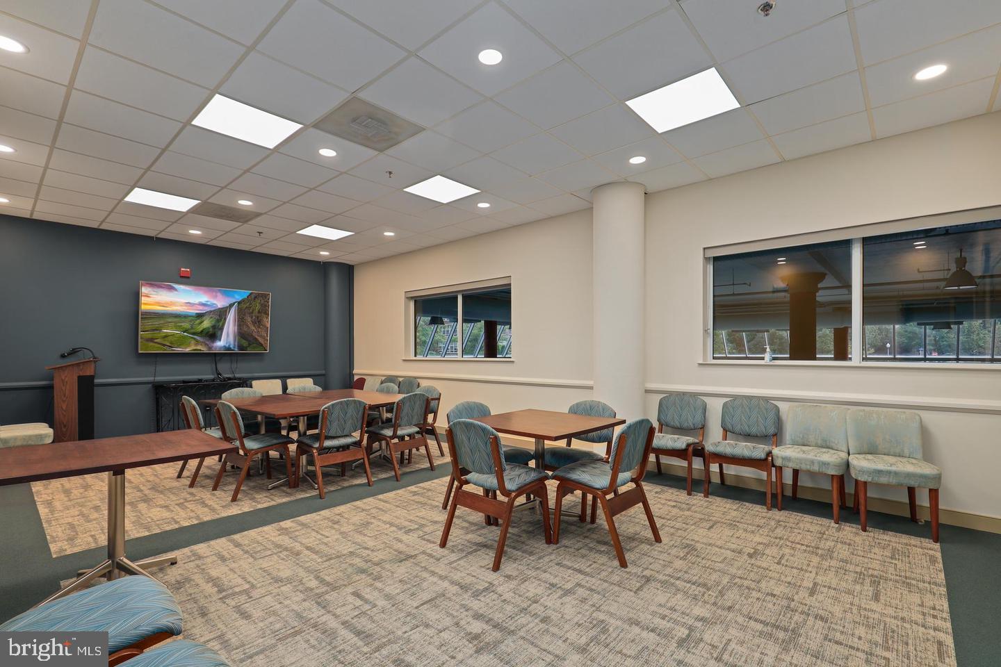 19385 Cypress Ridge Terrace, Unit 914 Leesburg, VA 20176 - Photo 38 of 39 a living room with furniture a flat screen tv and a table
