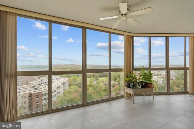 a lobby with furniture and large windows