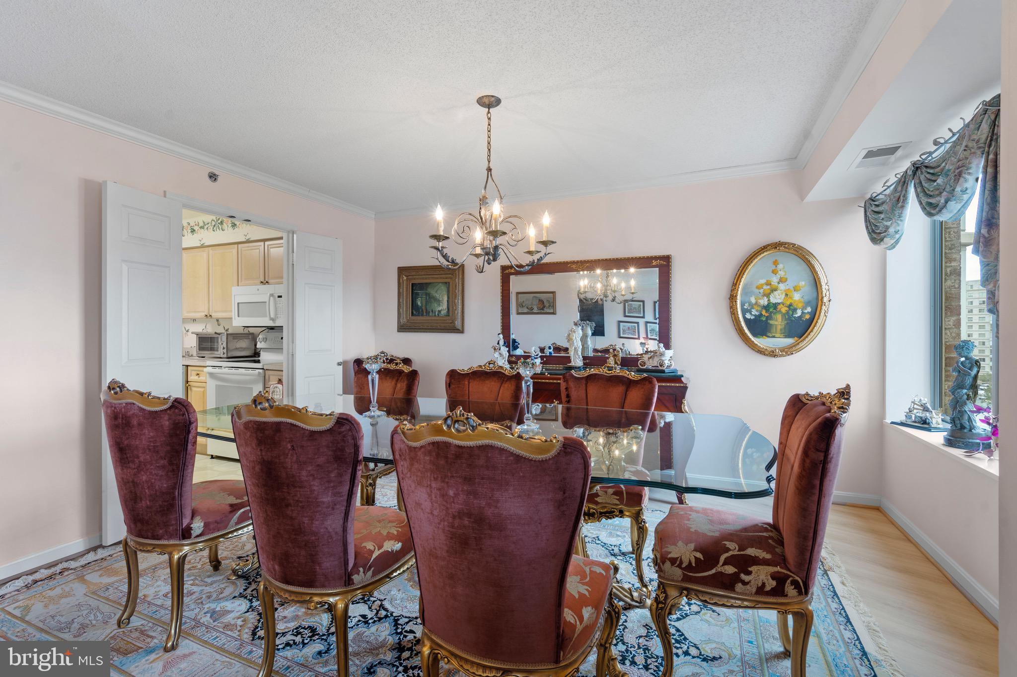 19385 Cypress Ridge Terrace, Unit 914 Leesburg, VA 20176 - Photo 10 of 39 a view of a dining room with furniture window and wooden floor