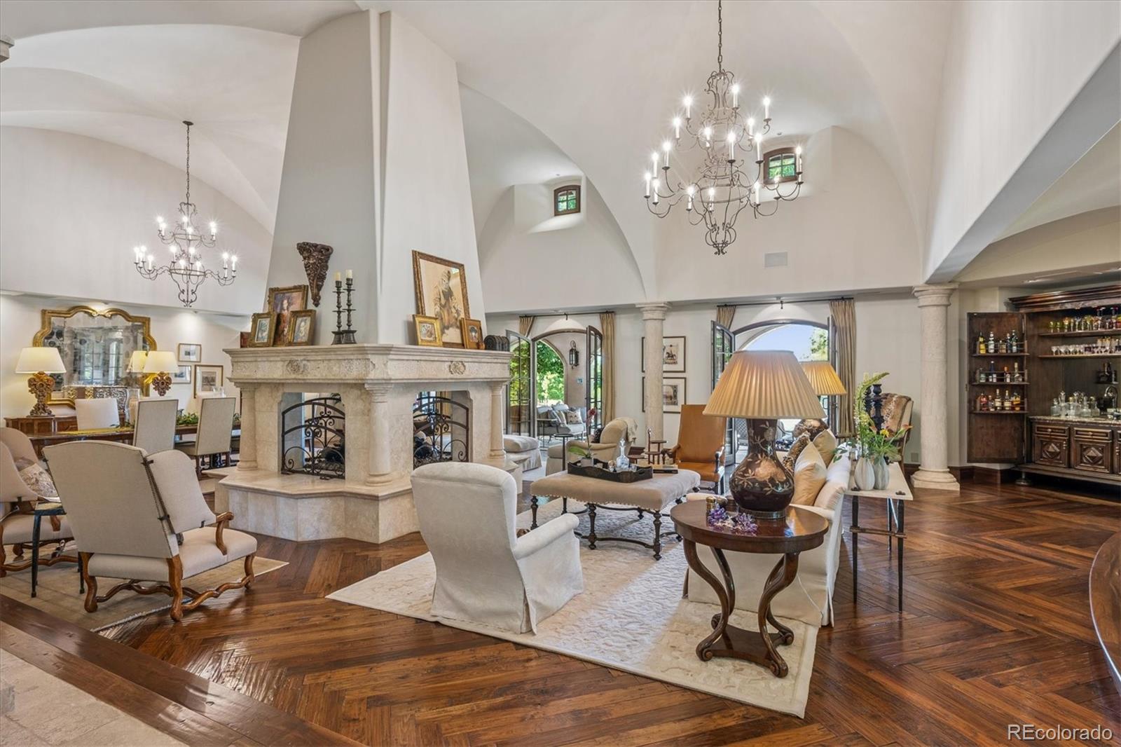 12 Lynn Road Cherry Hills Village, CO 80113 - Photo 2 of 50 a living room with furniture a chandelier and a fireplace