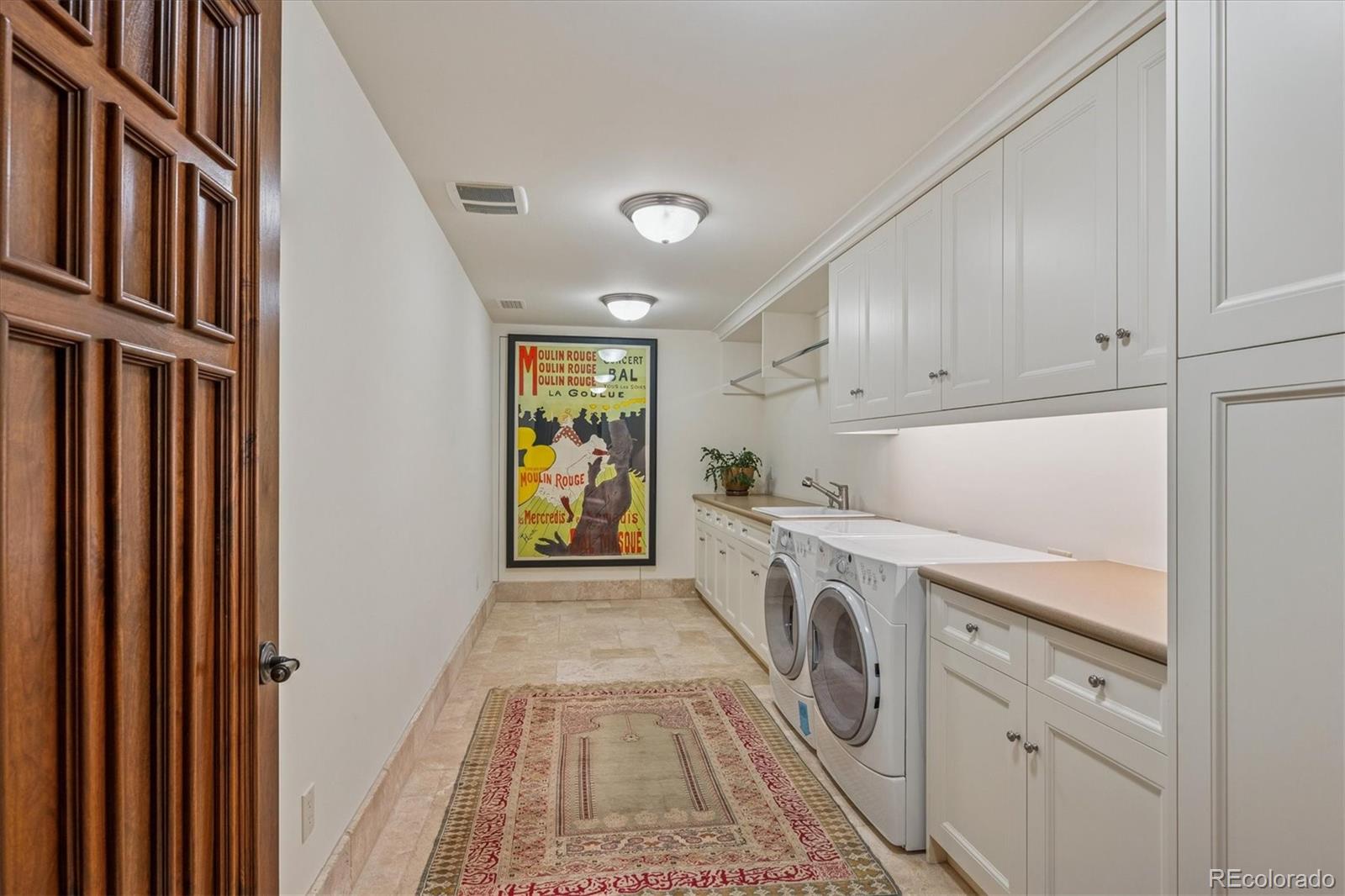 12 Lynn Road Cherry Hills Village, CO 80113 - Photo 25 of 50 a utility room with cabinets washer and dryer