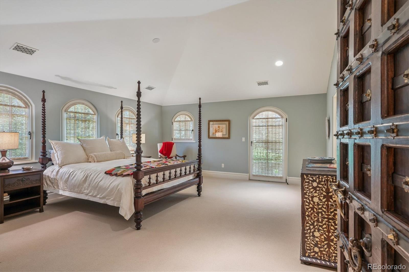 12 Lynn Road Cherry Hills Village, CO 80113 - Photo 26 of 50 a spacious bedroom with a bed a chandelier and dresser