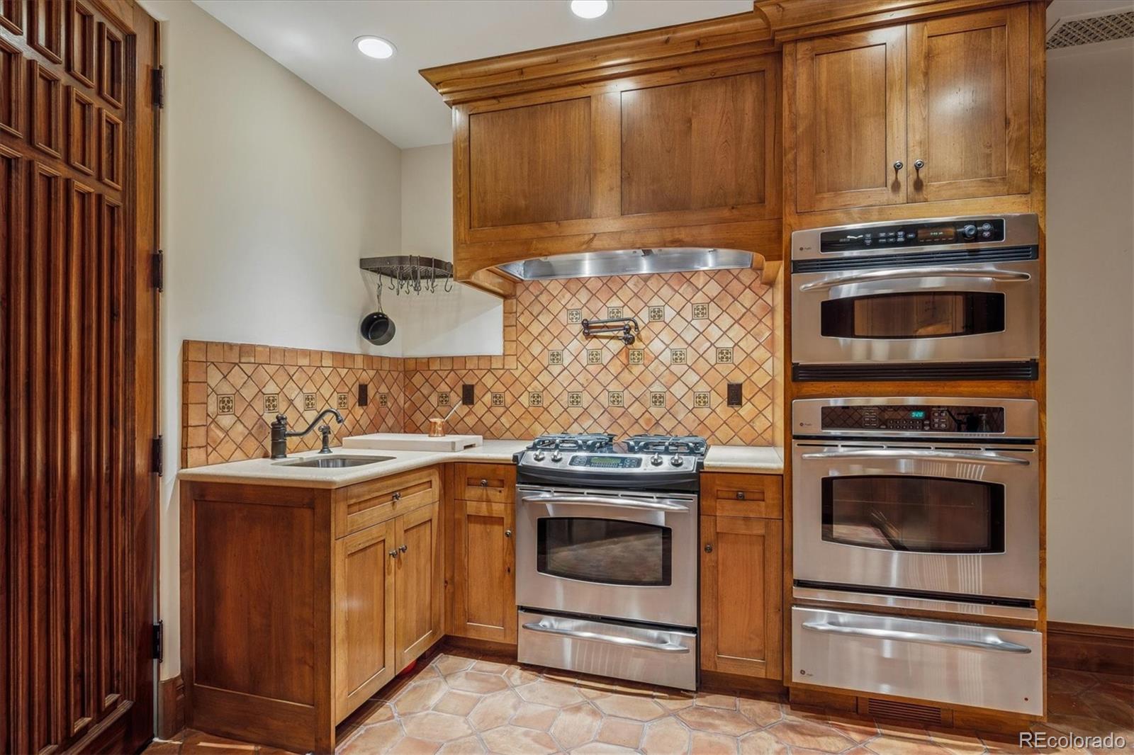 12 Lynn Road Cherry Hills Village, CO 80113 - Photo 30 of 50 a kitchen with a stove and a microwave