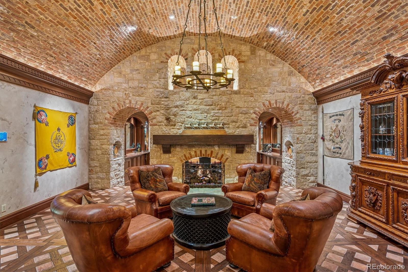 12 Lynn Road Cherry Hills Village, CO 80113 - Photo 33 of 50 a living room with furniture a fireplace and a chandelier