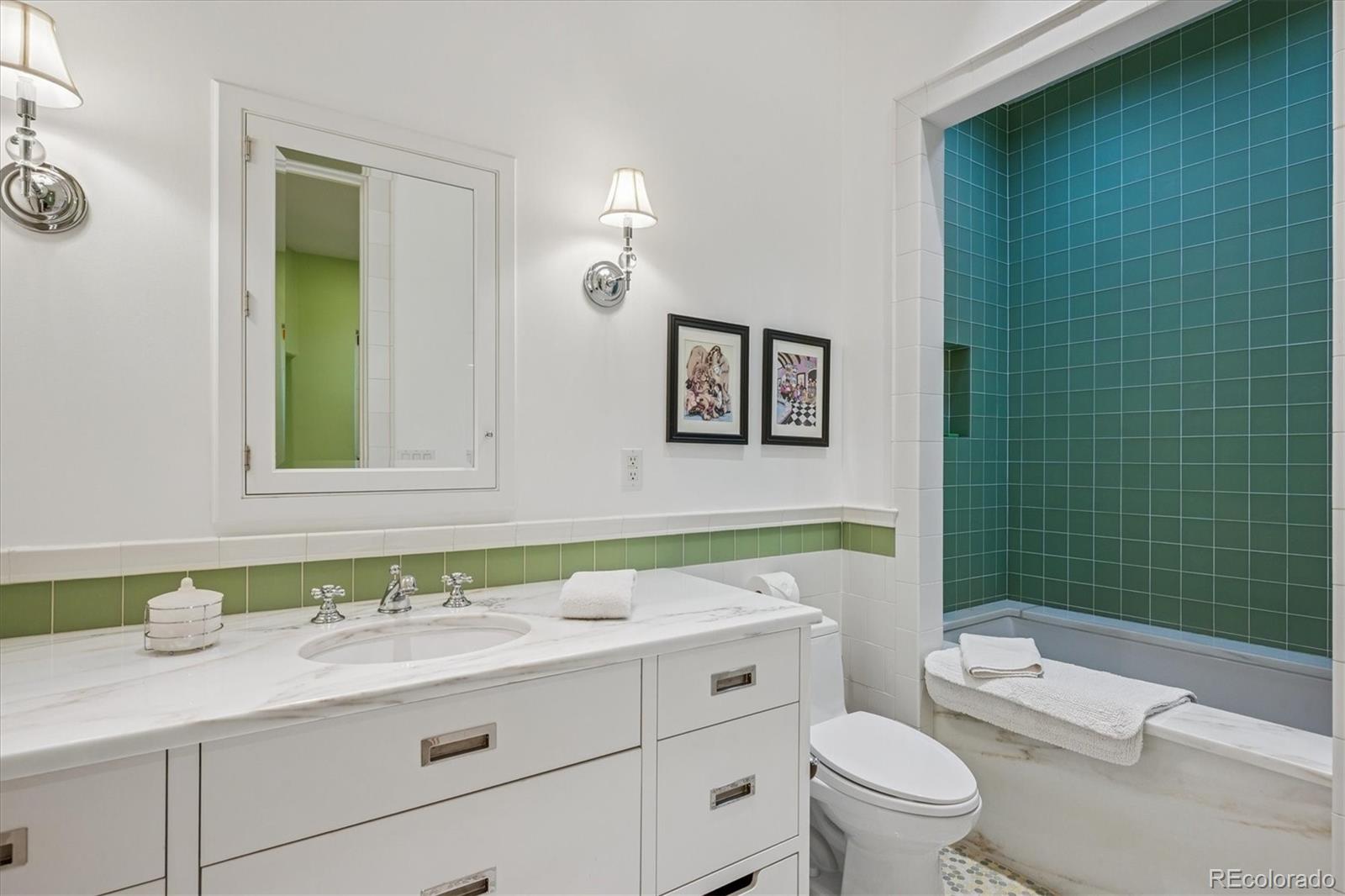 12 Lynn Road Cherry Hills Village, CO 80113 - Photo 44 of 50 a bathroom with a granite countertop toilet a sink and a mirror