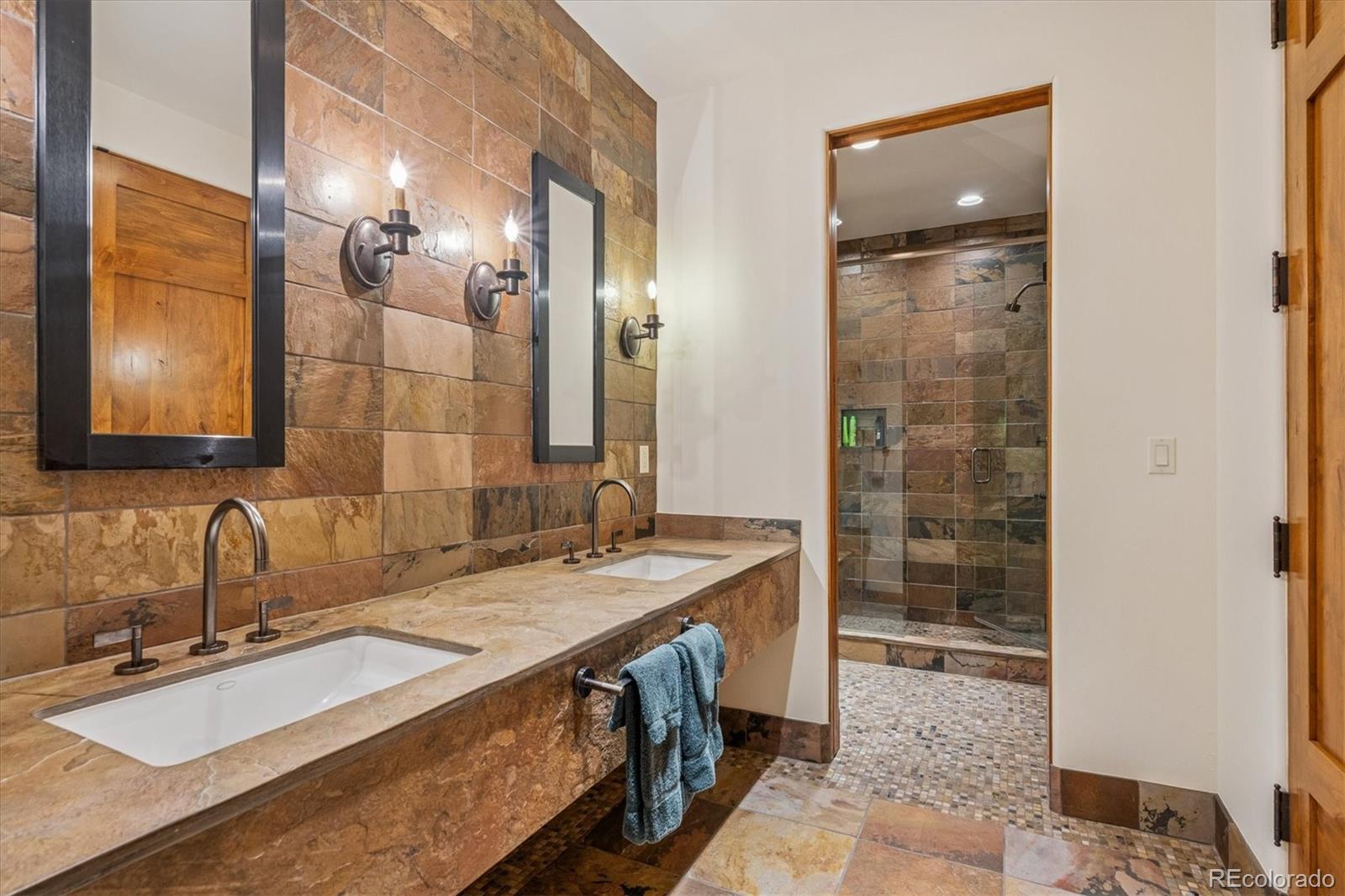 12 Lynn Road Cherry Hills Village, CO 80113 - Photo 49 of 50 a bathroom with a granite countertop sink a mirror and a shower