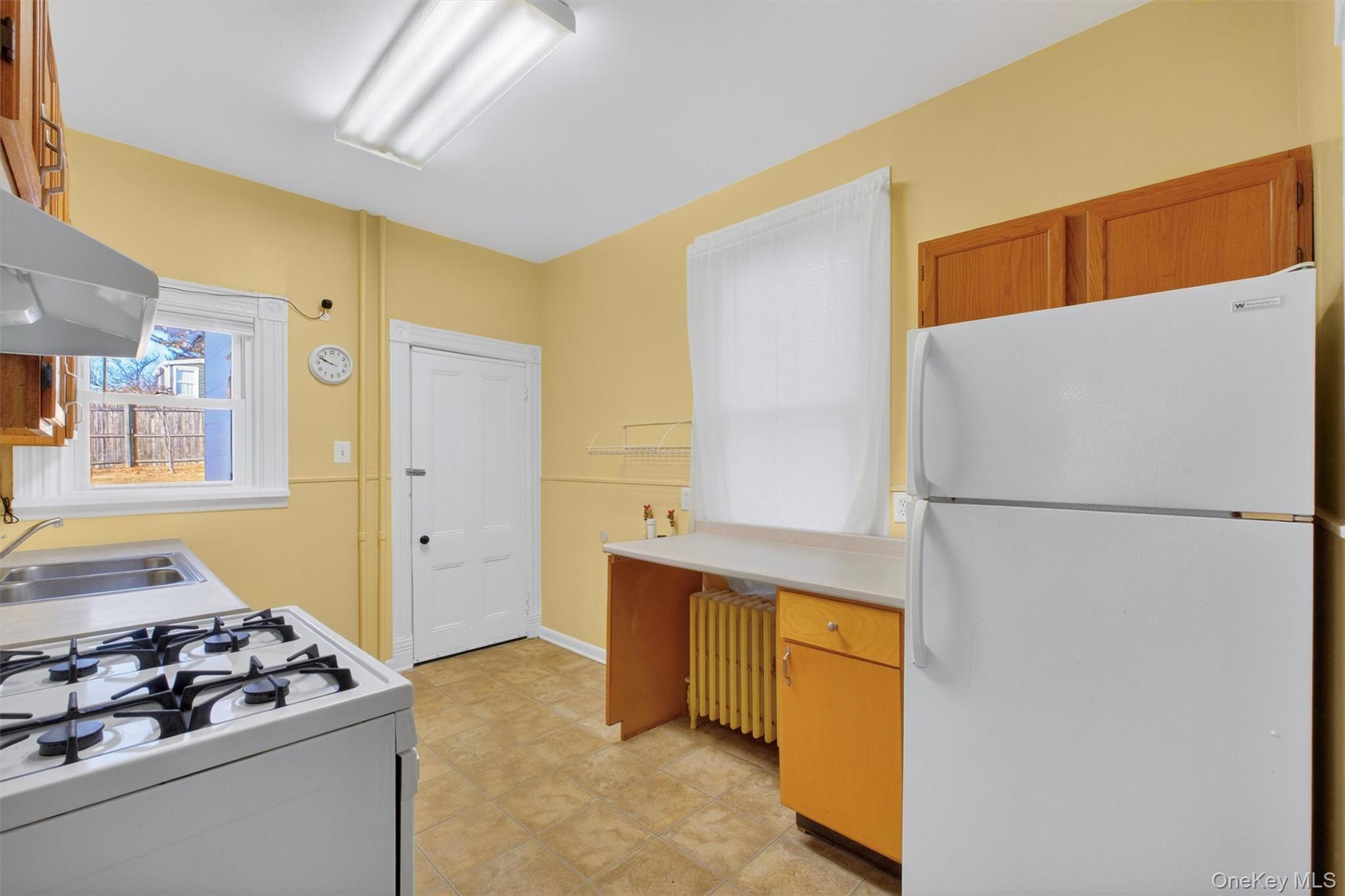 75 Prospect Street Newburgh, NY 12550 - Photo 15 of 37 a white refrigerator freezer and a stove sitting inside of a kitchen