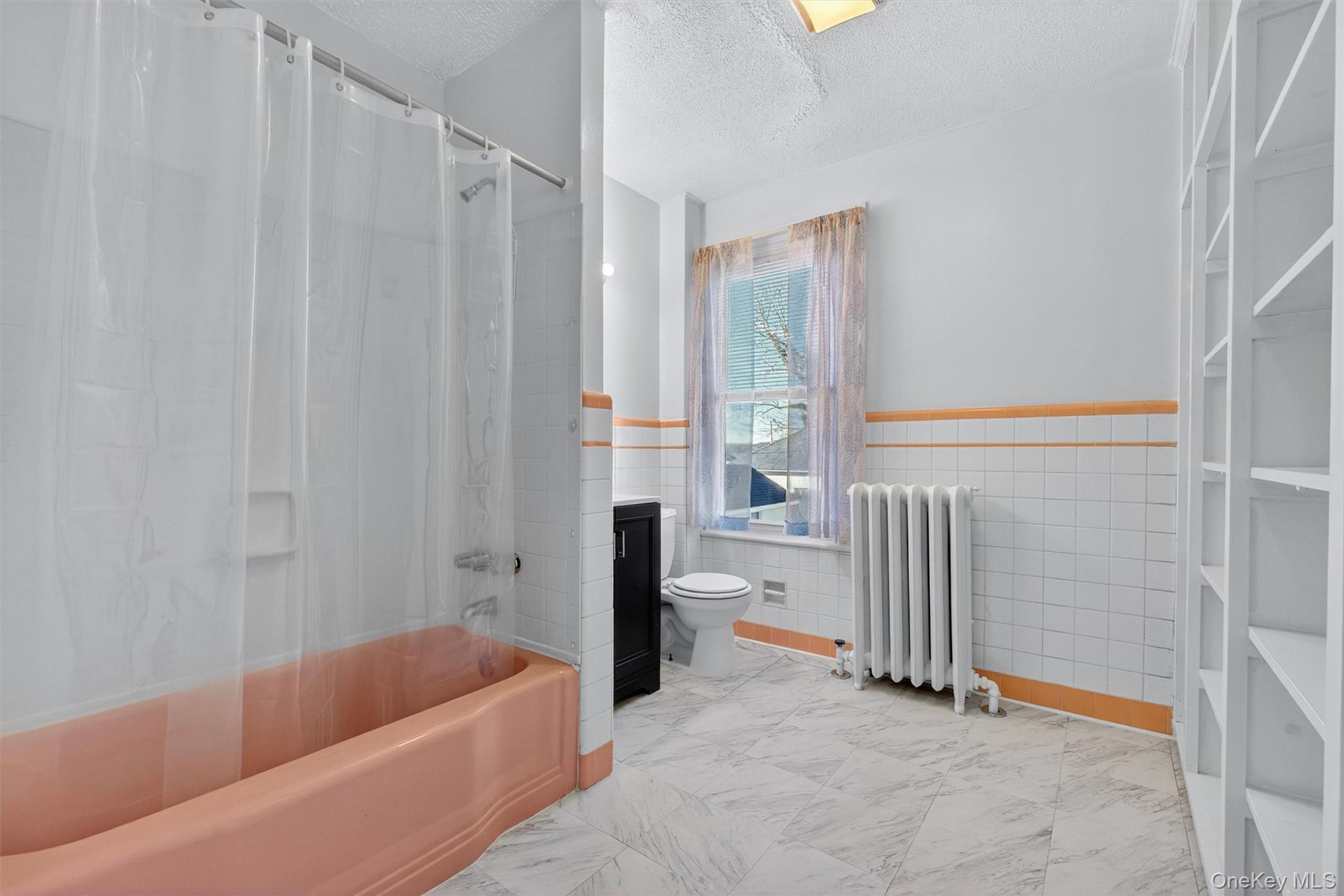 75 Prospect Street Newburgh, NY 12550 - Photo 22 of 37 a bathroom with a tub a sink and a window