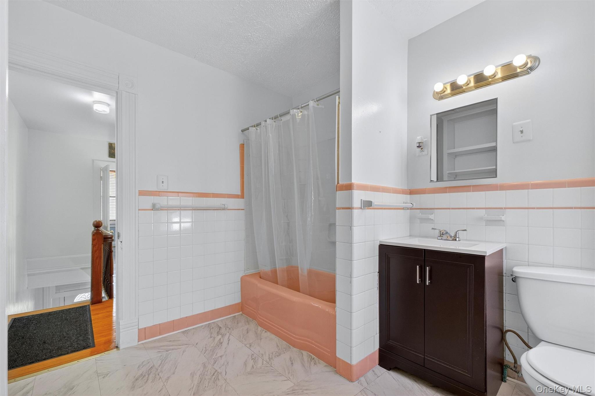 75 Prospect Street Newburgh, NY 12550 - Photo 23 of 37 a bathroom with a sink a toilet and a mirror