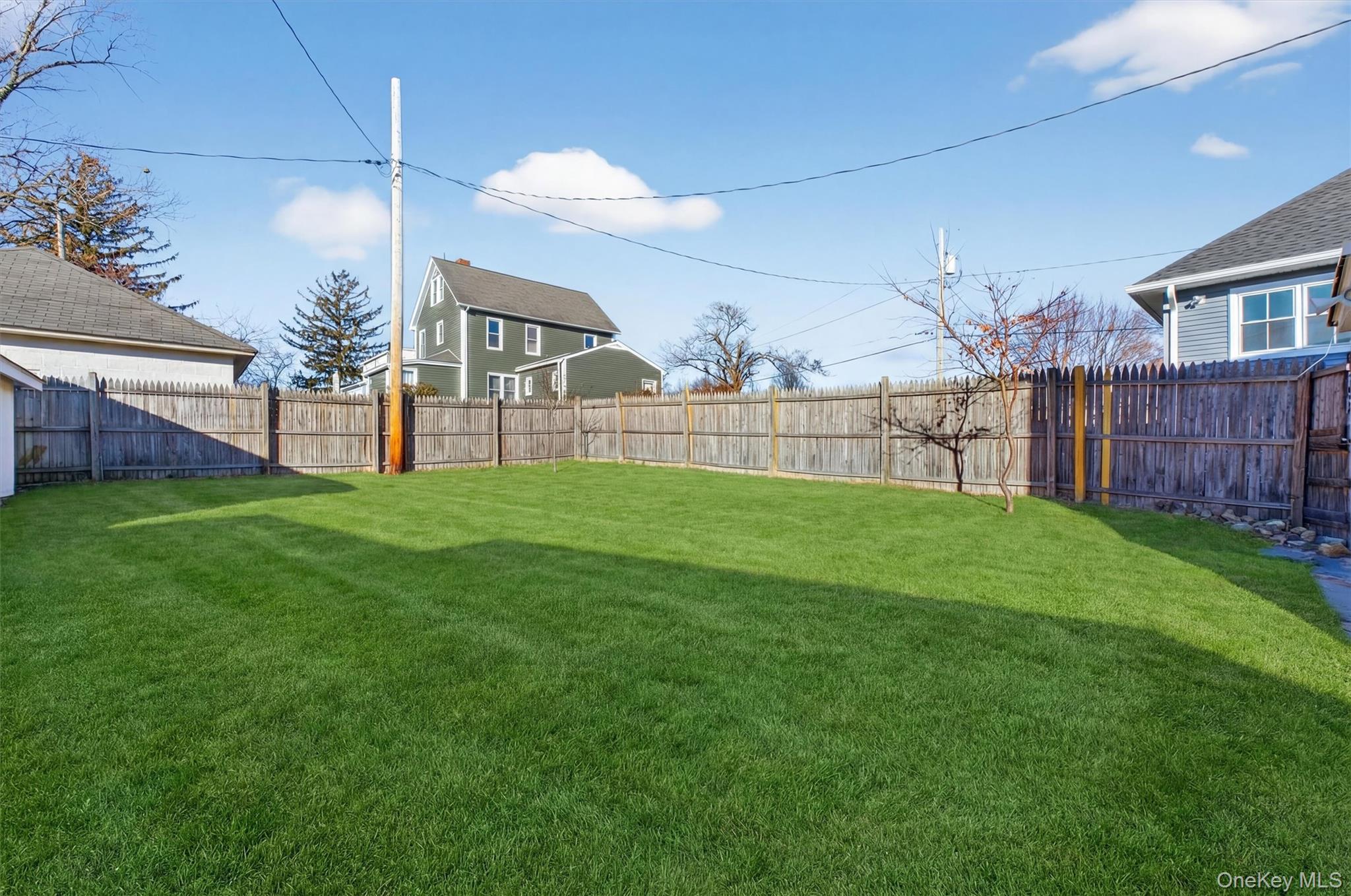 75 Prospect Street Newburgh, NY 12550 - Photo 33 of 37 a view of a house with a yard and a fence
