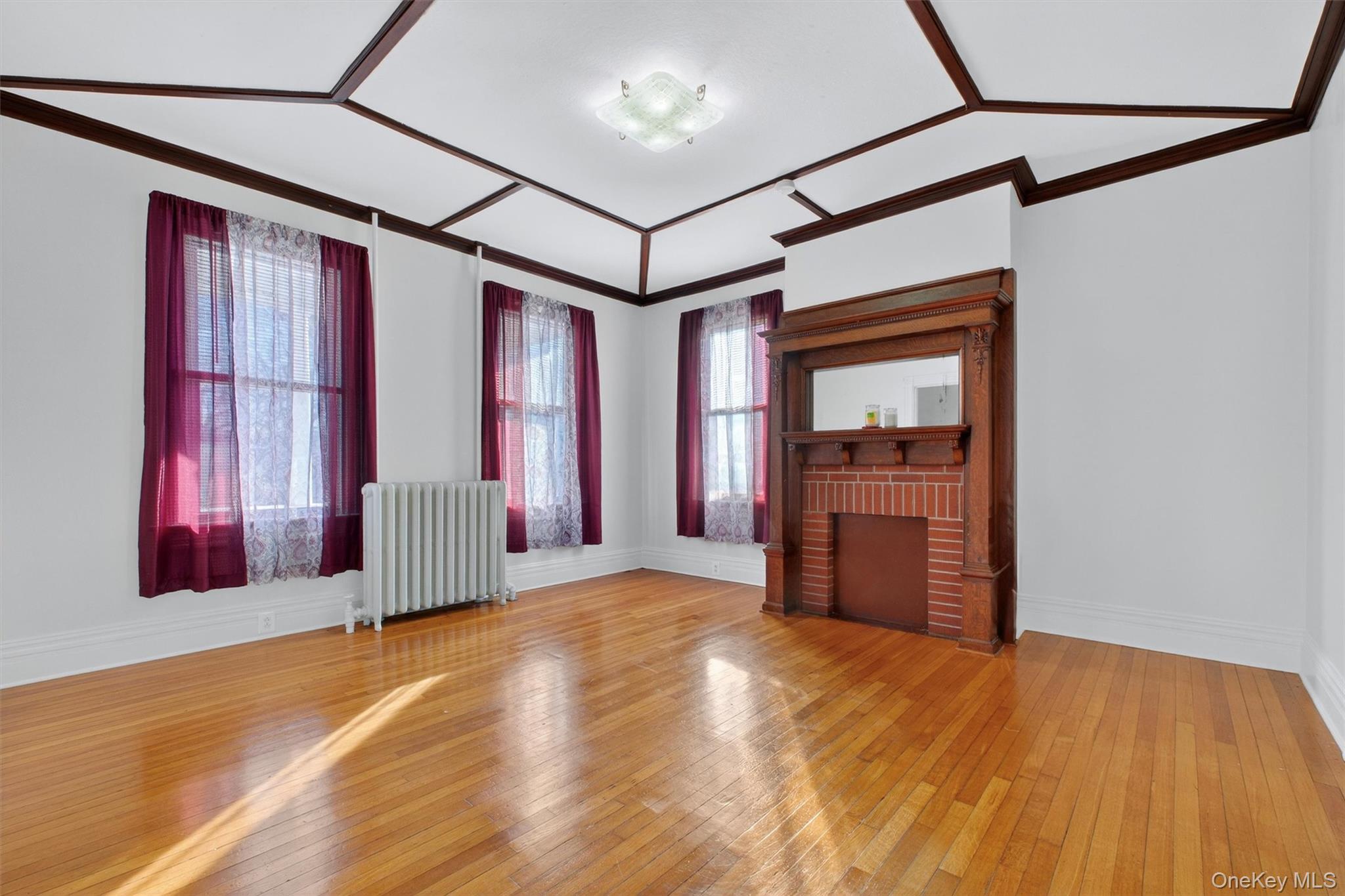 75 Prospect Street Newburgh, NY 12550 - Photo 9 of 37 a view of a hallway with wooden floor and windows