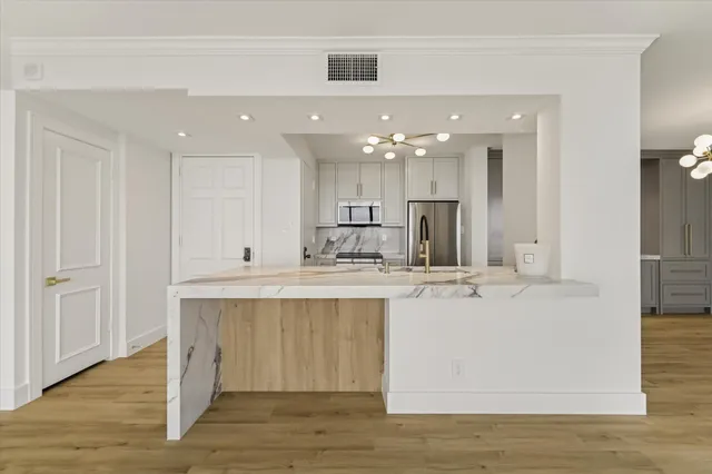 a kitchen with a sink and large window