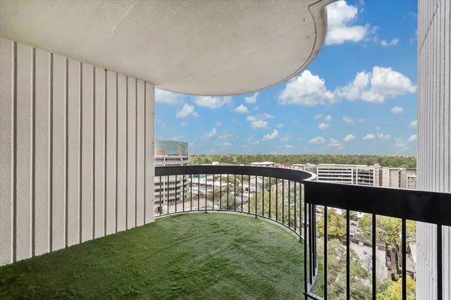 a view of a tall building next to a lake