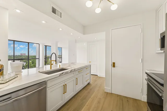 a large kitchen with a lot of counter space and a wooden floor