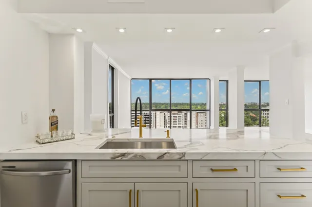 a kitchen with a sink and large window