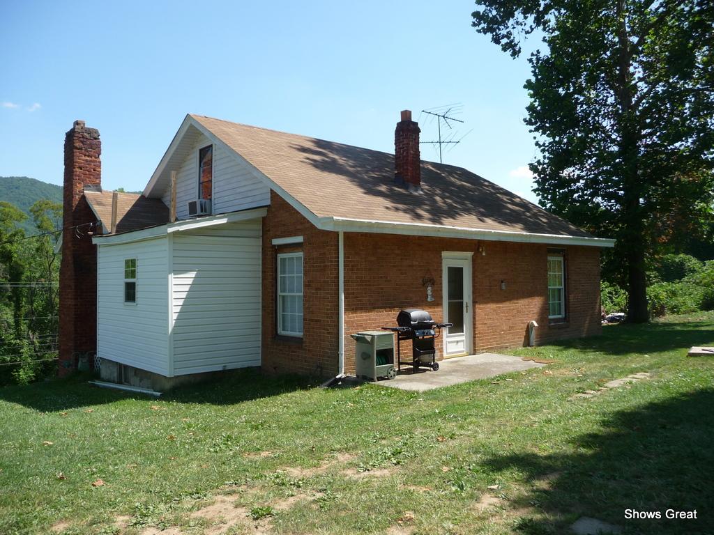 1533 Webster Road Roanoke, VA 24012 - Photo 5 of 10 a front view of a house with a garden and chairs