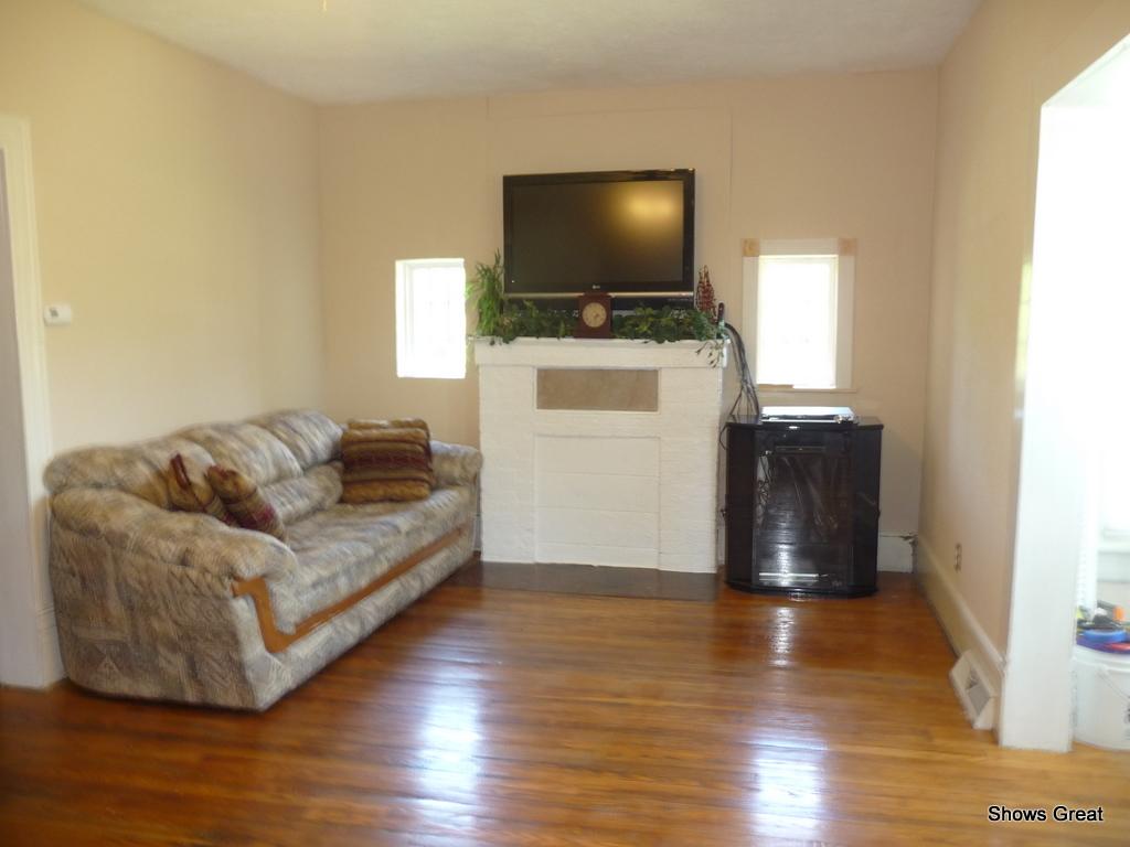 1533 Webster Road Roanoke, VA 24012 - Photo 6 of 10 a living room with furniture and a flat screen tv