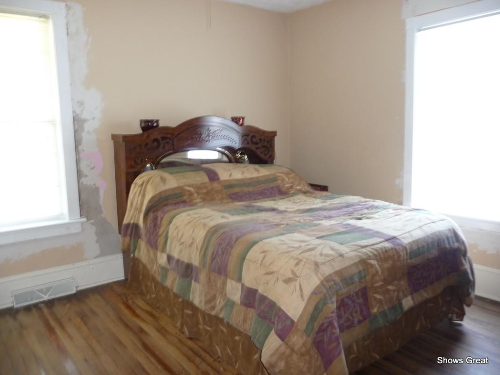 1533 Webster Road Roanoke, VA 24012 - Photo 9 of 10 a bedroom with a bed and wooden floor